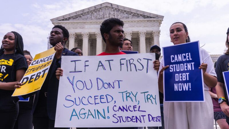 Protesters stand outside the U.S. Supreme Court building with signs calling for President Biden to continue trying to cancel student loan debt.