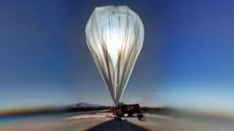 The Stratollite high-altitude balloon by World View Enterprises inflating on a launch pad.