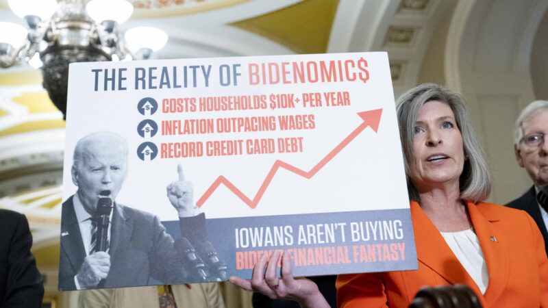Joni Ernst, R-IA, holds a poster on "Bidenomics"