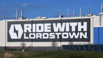 Lordstown Motors' Ohio plant, with a large "RIDE WITH LORDSTOWN" banner on the side.